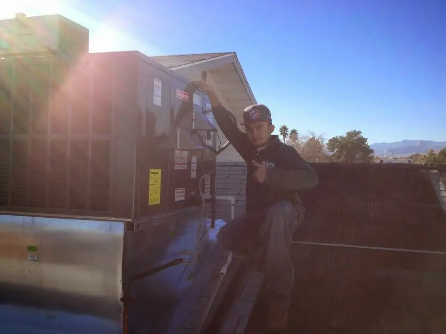 HVAC technician performing AC Tune-Up on a rooftop unit in Shillington